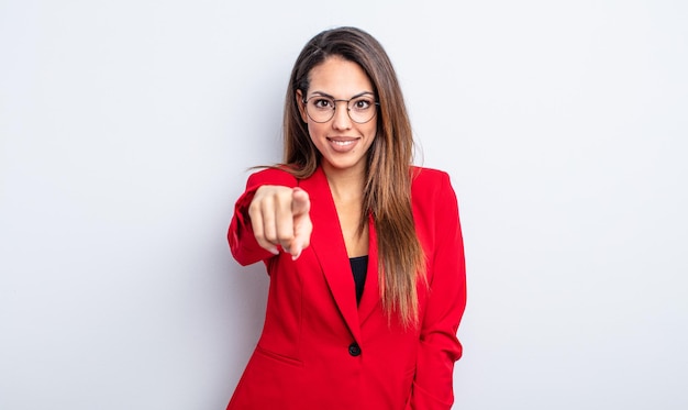 Pretty hispanic woman pointing at camera choosing you. businesswoman concept