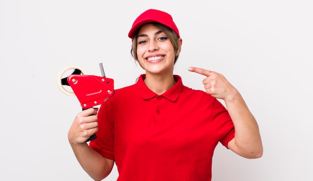 Pretty hispanic woman smiling confidently pointing to own broad smile packer concept