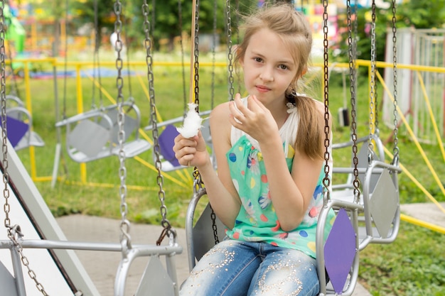 Pretty little girl eating candy floss