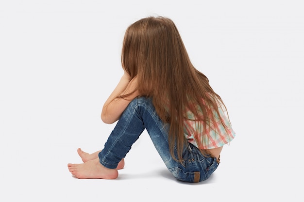 Pretty little  girl sitting on the floor