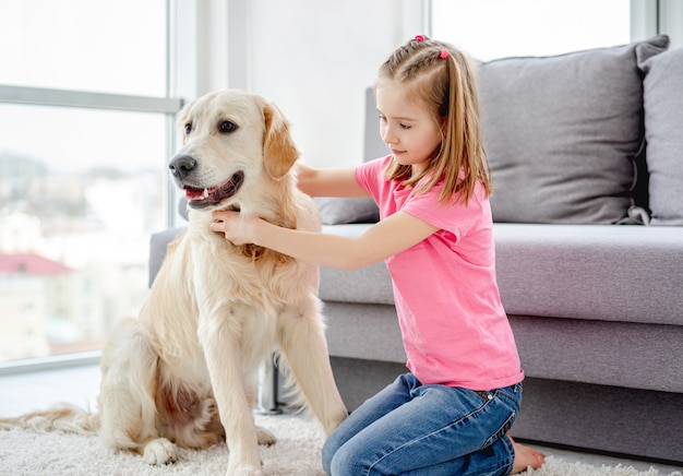 Pretty little girl with golden retriever