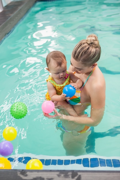 Pretty mother and baby at the swimming pool