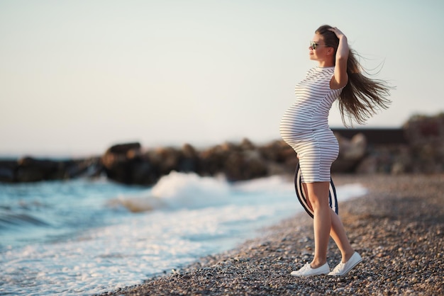 pretty pregnant woman near the sea