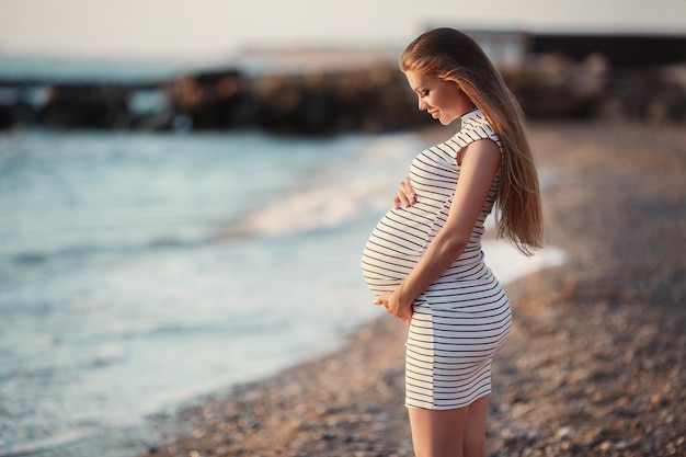 pretty pregnant woman near the sea