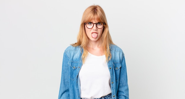 Photo pretty red head woman feeling disgusted and irritated and tongue out