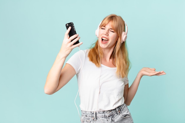 pretty red head woman with headphones