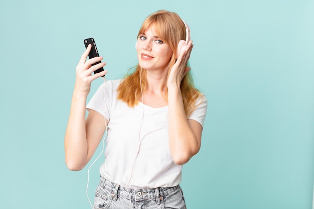 Pretty red head woman with headphones