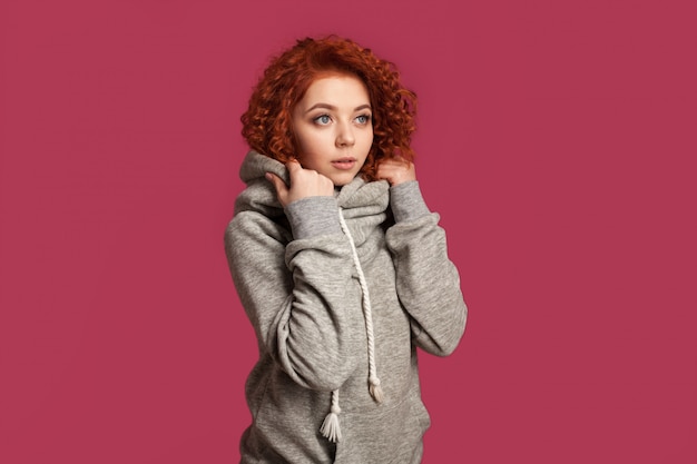 Pretty redhead curly girl dressed hoodie