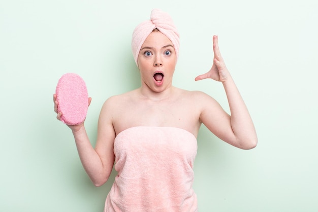 Pretty redhead woman having a shower concept