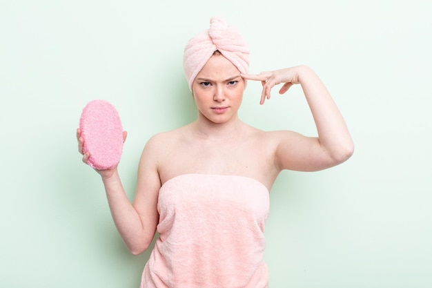 Pretty redhead woman having a shower concept