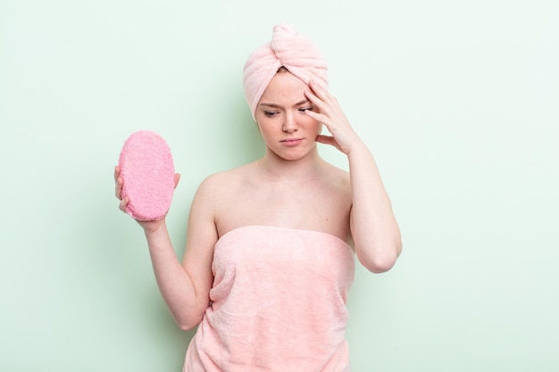 Pretty redhead woman having a shower concept