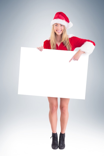 Pretty santa girl holding poster