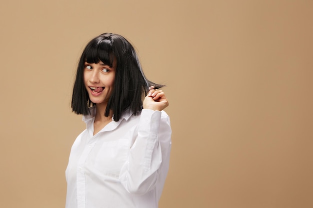 Pretty sexy beautiful stylish adorable brunet lady in white shirt posing isolated on pastel beige studio background Copy space Banner Offer Pulp Fiction concept Fashion Cinema