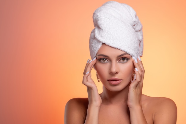 Pretty smiling girl with a towel on her head