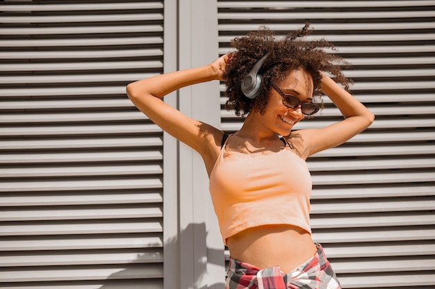 A pretty smiling woman in headphones feeling enjoyed