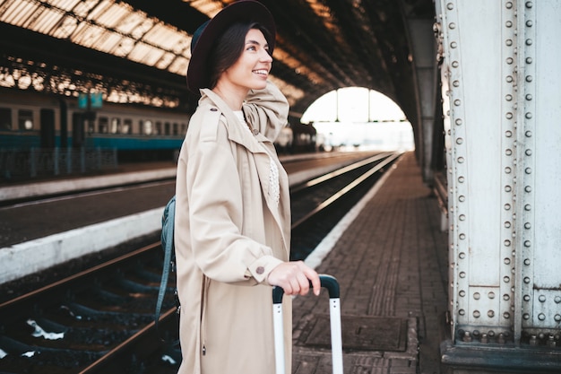 Pretty smiling woman at the railway station.