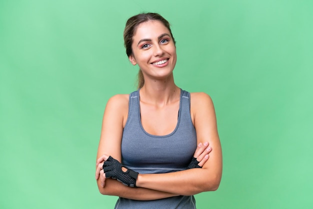 Pretty Sport Uruguayan woman over isolated background keeping the arms crossed in frontal position