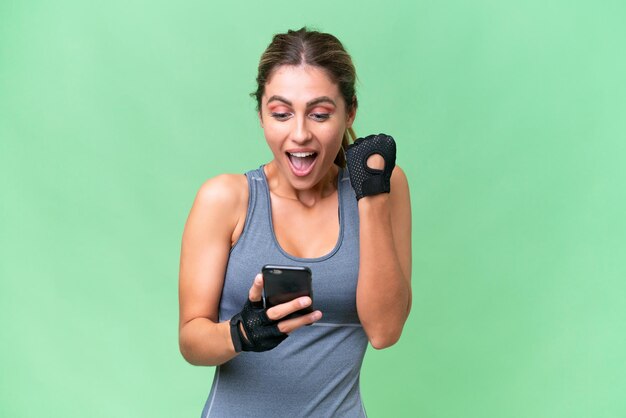 Pretty Sport Uruguayan woman over isolated background surprised and sending a message