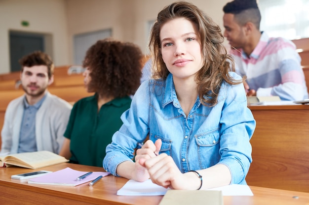 Pretty student girl at university class