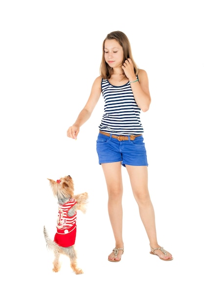 Pretty teen girl feeding cute little dog