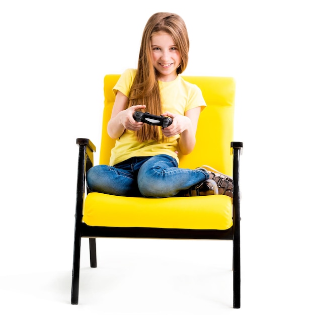 Pretty teen girl sitting holding black joystick playing console for computer games