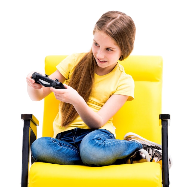 Pretty teen girl sitting holding black joystick playing console for computer games