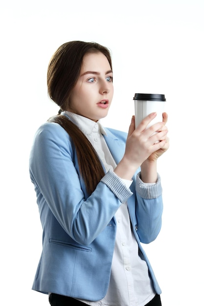 Pretty teenager looking shocked at coffee