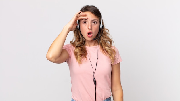 Pretty thin woman looking happy, astonished and surprised .operator assistant  with a headset