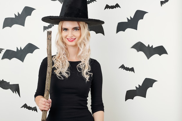 Pretty witch posing with broom