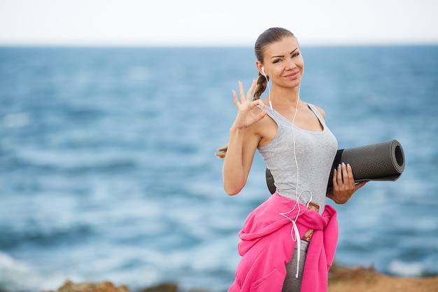 pretty woman after fitness and yoga by the sea