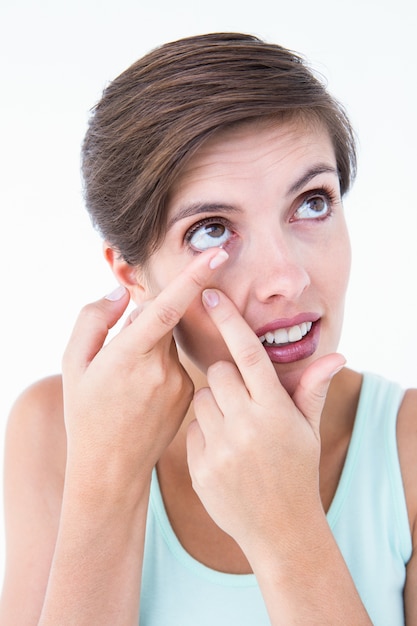 Pretty woman applying contact lens