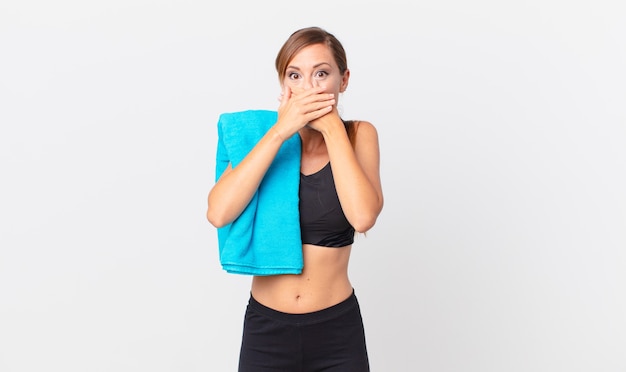 Pretty woman covering mouth with hands with a shocked. fitness concept