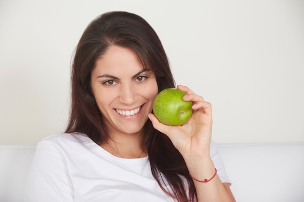 Pretty woman holding green apple