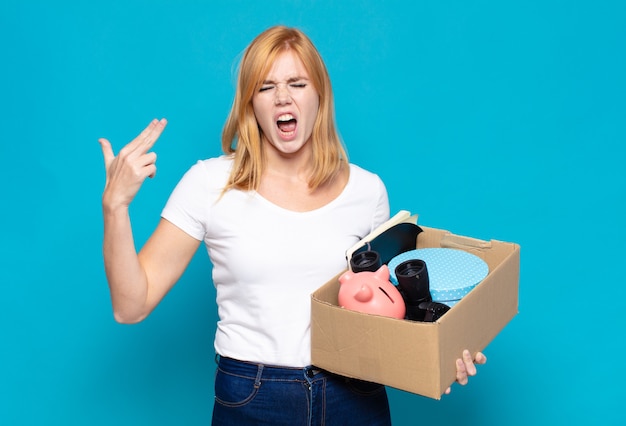 Pretty woman  looking unhappy and stressed, suicide gesture making gun sign with hand, pointing to head