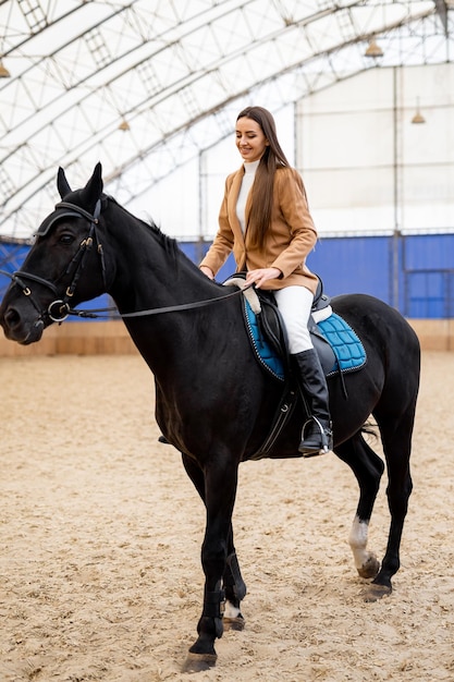 Pretty woman riding on horse Outdoor horseback rider lady