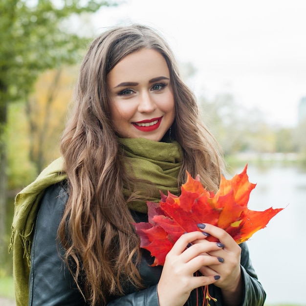 Pretty woman walking in autumn park outdoor