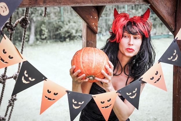 Pretty woman in witch costume at halloween party