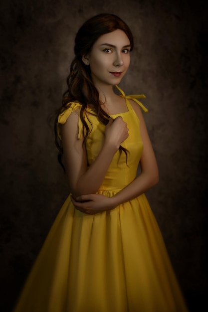 Pretty woman in the yellow dress closeup with red rose in her handsBeauty and the beast cosplay