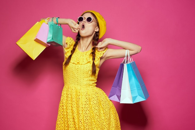 Pretty woman yellow dress shopping fun isolated background