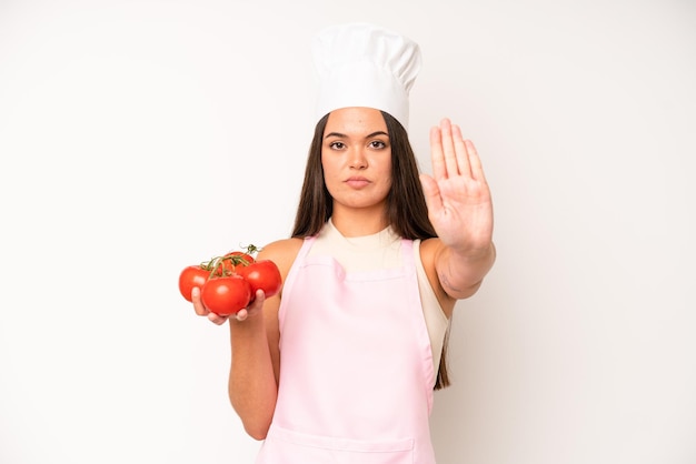 Pretty young adult woman chef and ingredients healthy food concept