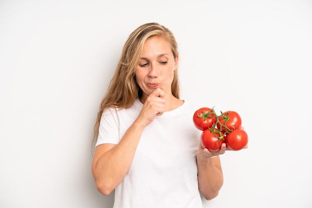 Pretty young adult woman with tomatoes