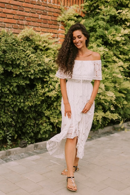 Pretty young curly hair woman in the park