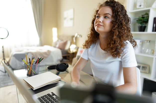 Pretty young entrepreneur woman working with laptop sitting in the office