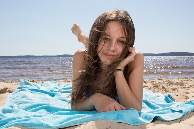 pretty young girl on the beach at summertime