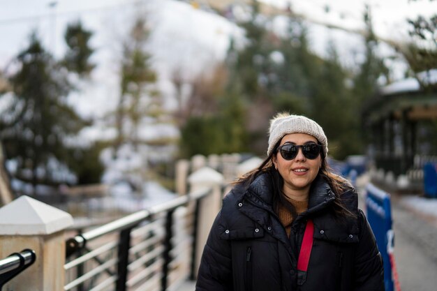 Pretty young girl bundled up in ski village smiling