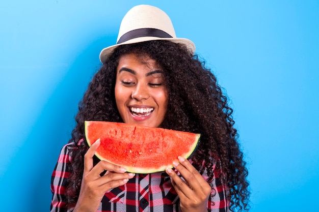 Pretty young girl holding slice of watermelon in front of her face. Portrait of smiling african american girl isolated   Healthy & Happy  