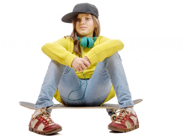 pretty young girl posing with a skateboard