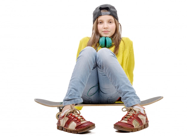 pretty young girl posing with a skateboard