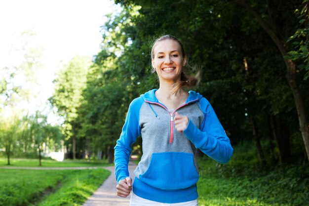 Pretty young girl runner in the forest