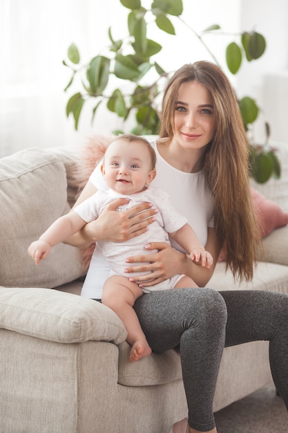 Pretty young mother holding her baby girl